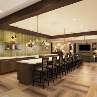 A spacious, modern kitchen with an island counter and bar stools.