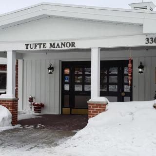 The entrance of TuTte Manor covered in snow during winter.