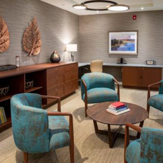 A cozy waiting room with modern furniture and decorative elements.