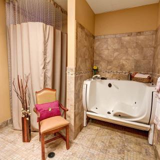 A cozy bathroom featuring an accessible bathtub and elegant decor.