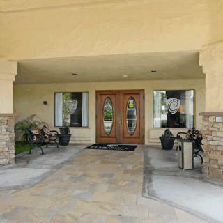 A welcoming building entrance with double wooden doors and decorative stone accents.
