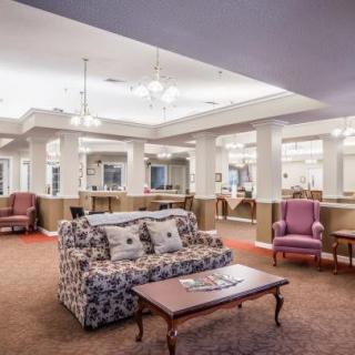 A spacious living room with elegant furniture and soft lighting.