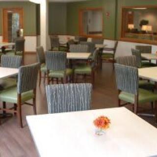 A modern and neatly arranged dining area with several tables and chairs.