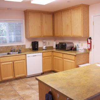 A well-equipped kitchen featuring wooden cabinets and modern appliances.