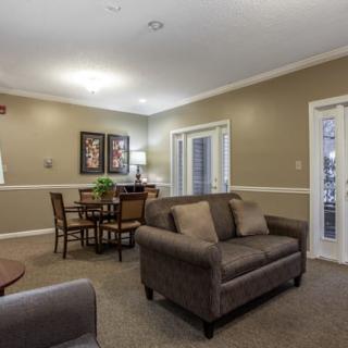 Cozy living room with a sofa and dining area.