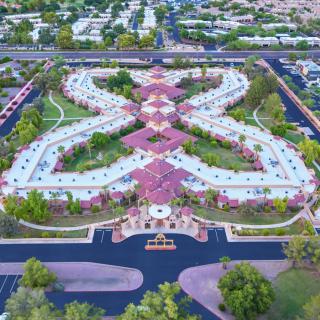 Aerial view of a beautifully designed park with intricate pathways and lush greenery.