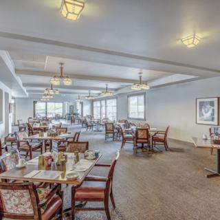 An elegantly designed restaurant dining area with neatly arranged tables and chairs.