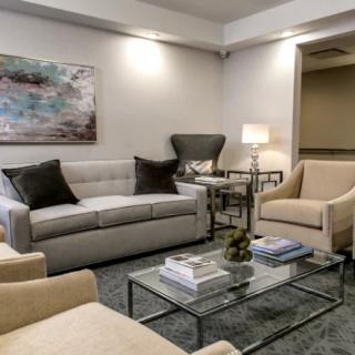 A cozy, well-decorated living room featuring comfortable seating and modern decor.
