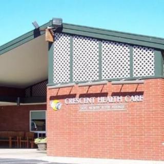 Exterior view of a healthcare clinic with brick walls and an entrance sign.