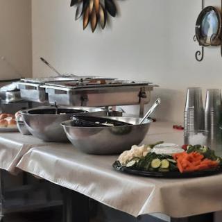 A beautifully arranged buffet setup featuring various salads and serving dishes.