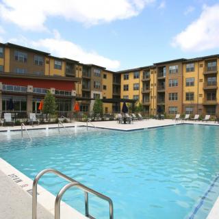 An outdoor swimming pool in a residential apartment complex.