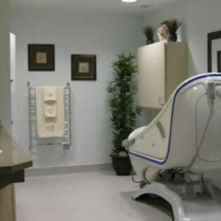 A modern bathroom with a sleek bathtub and decorative elements.
