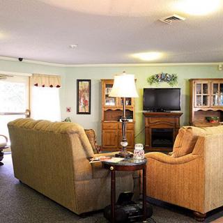 A cozy living room with comfortable seating and a television.