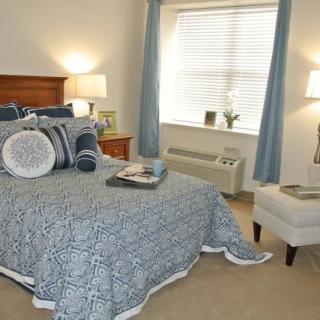 A cozy bedroom with blue-themed decor and soft lighting.