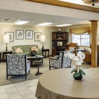 A cozy living room with elegant furniture and a home office area.