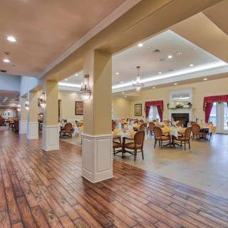 Spacious dining area with elegant lighting and wooden floors.