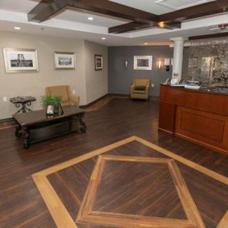 A stylish lobby with hardwood flooring, comfortable seating, and art on the walls.