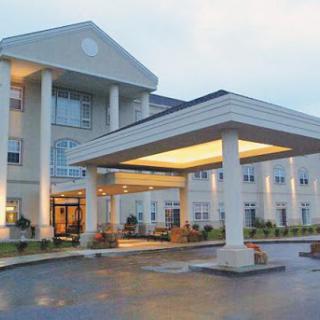A welcoming hotel entrance with elegant architecture and a well-lit canopy.
