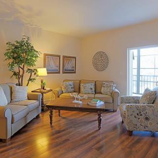 A cozy living room with comfortable seating and warm lighting.