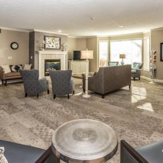 A modern and spacious living room with elegant furnishings and a fireplace.