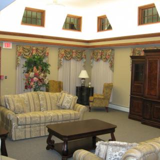 A traditional living room with sofas, a coffee table, and decorative elements.