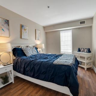 A modern and cozy bedroom with stylish decor and comfortable bedding.