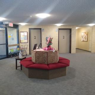 A welcoming lobby area featuring a decorative centerpiece and artworks on the walls.