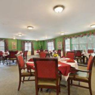 A well-decorated dining room with elegantly set tables and chairs.