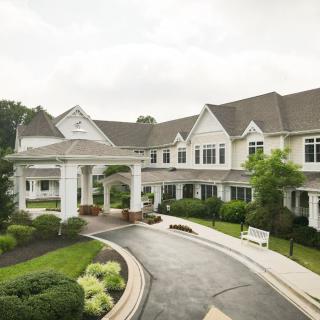 A large residential building with an elegant entrance and well-maintained landscaping.