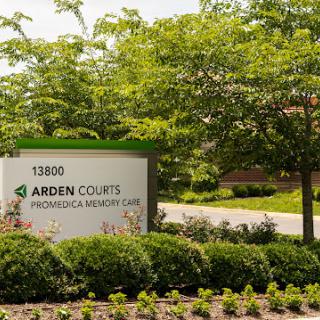 Entrance sign of Arden Courts, a memory care facility, surrounded by well-maintained landscaping.