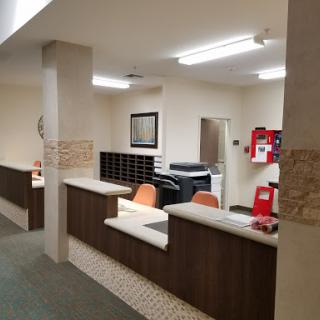 A view of a reception area in an office, featuring a counter and seating.