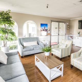 A modern, bright living room with comfortable seating and stylish decor.