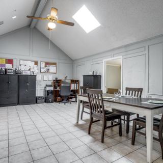 Spacious office interior with desks, chairs, and storage cabinets.