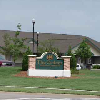 Entrance sign of a residential community featuring well-maintained landscaping.