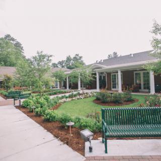 A tranquil outdoor space featuring well-maintained gardens and inviting benches.