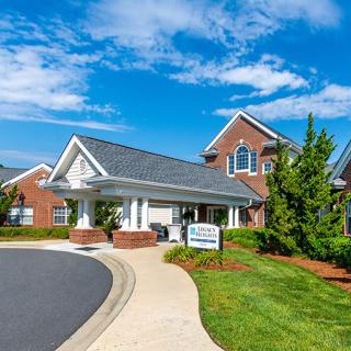 A beautiful residential building with well-maintained landscaping and a clear blue sky.