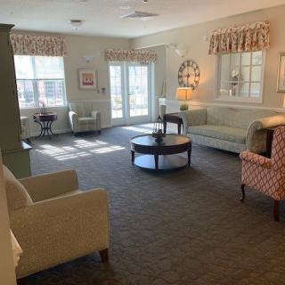 A cozy living room with stylish furnishings and natural light streaming in through the windows.