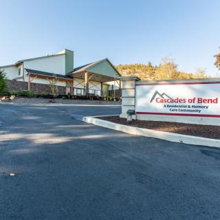 The entrance of the Cascades of Bend, a senior living community, with its sign prominently displayed.