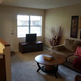 Cozy living room with a sofa, television, and coffee table.