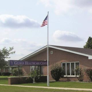 A brick church with an American flag flying on a flagpole.
