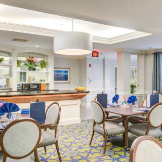 A modern dining area with elegant furnishings and warm lighting.