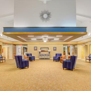 A spacious lobby with comfortable seating arrangements and decorative lighting.