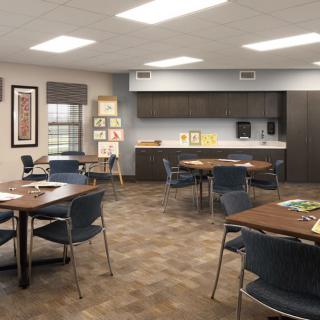 A modern classroom setup with tables and chairs arranged for collaborative learning.