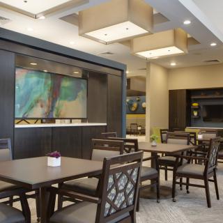 A modern dining space with neatly arranged tables and chairs.