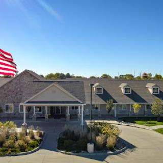 A welcoming residential building with an American flag waving in front.