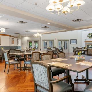 Spacious and elegantly decorated dining area with multiple tables and comfortable seating.