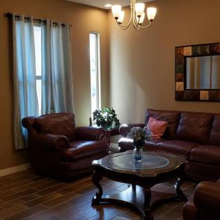 A cozy living room with leather seating and elegant decor.