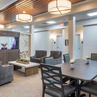 A modern lounge with comfortable seating and a meeting table.