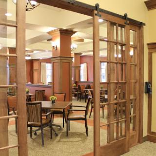 A cozy dining area featuring wooden sliding doors and ample seating.
