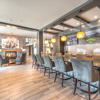 A modern bar interior with elegant seating and warm lighting.